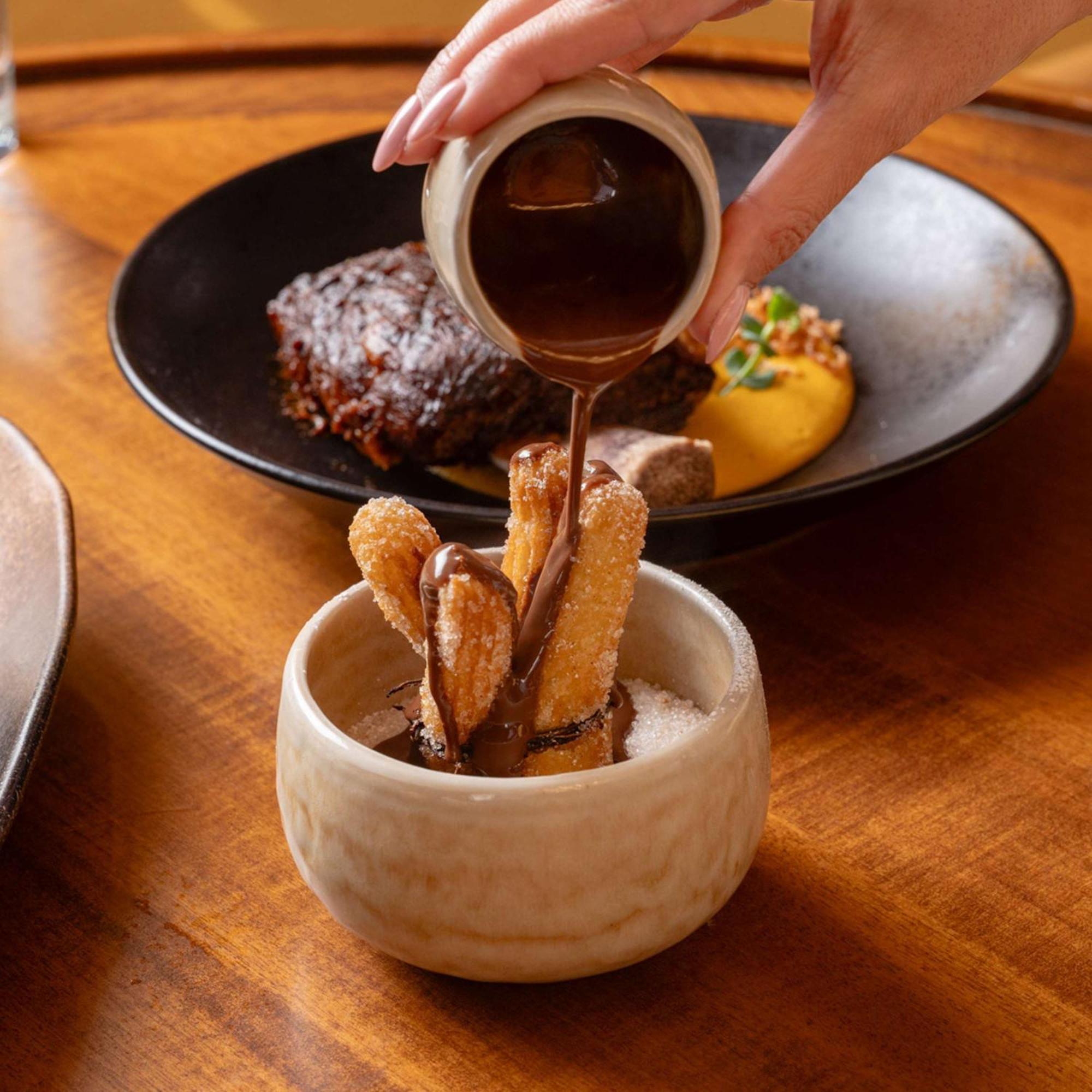 V Hotel Dubai, Curio Collection By Hilton Ngoại thất bức ảnh Soy sauce being poured on tempura